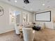 Cozy living room with projector, screen, comfortable seating, and neutral decor at 3155 Kedleston Ave, Highlands Ranch, CO 80126