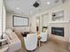 Spacious living room featuring a projector screen, fireplace, comfortable seating, and neutral color palette at 3155 Kedleston Ave, Highlands Ranch, CO 80126