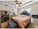 Luxurious main bedroom with a large bed, mirrored dresser, ceiling fan, and natural light from the windows at 3155 Kedleston Ave, Highlands Ranch, CO 80126