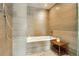 Modern bathroom with shower featuring a built-in bench and stylish tile surround at 1750 Wewatta St # 834, Denver, CO 80202