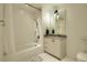 Cozy bathroom with a shower-tub combo, modern vanity, and decorative mirror with lighting at 1750 Wewatta St # 834, Denver, CO 80202