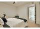Well-lit bedroom with ceiling fan, comfortable bed, and view to hallway at 1750 Wewatta St # 834, Denver, CO 80202