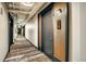 Hallway view with patterned carpet and leading to apartment at 1750 Wewatta St # 834, Denver, CO 80202