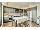 Modern kitchen with gray cabinetry, stainless steel appliances, and a center island with seating at 1750 Wewatta St # 834, Denver, CO 80202