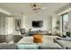 Spacious living room with stylish furnishings, modern lighting, and large windows with city views at 1750 Wewatta St # 834, Denver, CO 80202