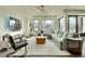 Bright living room with hardwood floors, an area rug, and windows with city views at 1750 Wewatta St # 834, Denver, CO 80202