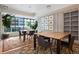 Bright office space with large windows, wooden tables, colorful rug, and modern decor, perfect for a collaborative work environment at 1750 Wewatta St # 834, Denver, CO 80202