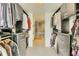 A spacious walk-in closet with custom shelving and rods for hanging clothes and accessories at 1750 Wewatta St # 834, Denver, CO 80202