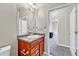 Bathroom featuring a sink with wood cabinets and a view into an adjacent room at 12444 Madison Way, Thornton, CO 80241