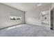 Bright bedroom with a large window, soft carpet, and neutral walls that create a peaceful atmosphere at 12444 Madison Way, Thornton, CO 80241
