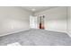 Spacious bedroom featuring neutral gray walls and plush carpeting leading to an ensuite bathroom at 12444 Madison Way, Thornton, CO 80241