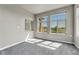 Bright room offers ample sunlight, neutral carpeting, and a relaxing space at 12444 Madison Way, Thornton, CO 80241