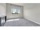 Cozy bedroom with plush carpeting and a large window offering natural light and scenic views at 12444 Madison Way, Thornton, CO 80241