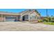 Charming home with stone accents, a two-car garage, and lush landscaping for curb appeal at 12444 Madison Way, Thornton, CO 80241