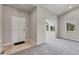 Welcoming foyer features neutral paint, new carpet, and a bright, open feel leading to other rooms at 12444 Madison Way, Thornton, CO 80241
