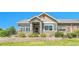 Charming home featuring manicured landscaping, a stone accent wall, and inviting curb appeal at 12444 Madison Way, Thornton, CO 80241