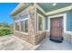 Inviting front porch featuring stone accents, a secure front door, and ample natural light at 12444 Madison Way, Thornton, CO 80241
