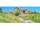 Well-maintained front yard featuring lush greenery, decorative landscaping, and a charming exterior at 12444 Madison Way, Thornton, CO 80241
