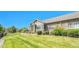 Beautifully landscaped front yard featuring healthy green grass, mature trees, and tasteful landscaping at 12444 Madison Way, Thornton, CO 80241