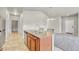Bright kitchen island with stainless steel sink offers open layout to the living and dining areas at 12444 Madison Way, Thornton, CO 80241