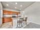 Well-lit kitchen features granite countertops, stainless steel appliances, and breakfast bar seating at 12444 Madison Way, Thornton, CO 80241