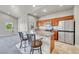 Kitchen features a breakfast bar, stainless steel appliances, and ample storage space at 12444 Madison Way, Thornton, CO 80241