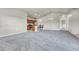 Living room showcasing neutral paint, modern lighting, bar seating, and open-concept design with a seamless flow into the kitchen at 12444 Madison Way, Thornton, CO 80241