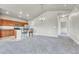Light-filled living room showcasing bar seating, modern lighting, an open-concept design, and seamless integration with the kitchen at 12444 Madison Way, Thornton, CO 80241