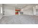Expansive living room featuring neutral paint, plush carpeting, a chandelier, and an open-concept design with seamless kitchen views at 12444 Madison Way, Thornton, CO 80241