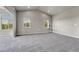 Comfortable living room with neutral paint, soft carpeting, modern lighting, and large windows offering scenic outdoor views at 12444 Madison Way, Thornton, CO 80241