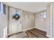 Well-lit entryway with wood floors, a window, and a white door with a decorative wreath at 2631 W 34Th Ave, Denver, CO 80211