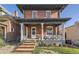 Charming two-story brick home featuring a welcoming front porch with classic white columns and inviting curb appeal at 2631 W 34Th Ave, Denver, CO 80211