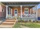 Inviting front porch showcasing classic columns, white railings, and a welcoming entrance to a charming home at 2631 W 34Th Ave, Denver, CO 80211