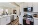 Modern kitchen features stainless steel appliances, white cabinets, and updated fixtures at 2631 W 34Th Ave, Denver, CO 80211