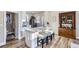 Modern kitchen with a marble countertop island, breakfast bar seating, and stylish cabinetry at 2631 W 34Th Ave, Denver, CO 80211