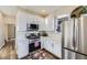 Bright kitchen features white cabinets, stainless steel appliances, and stylish accents at 2631 W 34Th Ave, Denver, CO 80211