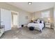 This main bedroom features soft carpet, a bed with throw pillows, and access to the hall at 2631 W 34Th Ave, Denver, CO 80211