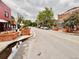 Charming street view with brick buildings, mature trees, and well-maintained sidewalks and brick landscaping at 2631 W 34Th Ave, Denver, CO 80211