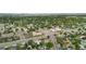 Aerial view of the neighborhood showing a quiet street and surrounding trees at 8820 Poze Blvd, Thornton, CO 80229
