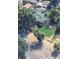 An aerial view of a house with a green roof, nestled among lush green trees at 8820 Poze Blvd, Thornton, CO 80229