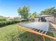 A spacious backyard featuring a trampoline and lush green lawn, perfect for outdoor activities at 8820 Poze Blvd, Thornton, CO 80229