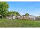 Spacious backyard featuring a large grassy area, a shed, a clothesline, and mature trees at 8820 Poze Blvd, Thornton, CO 80229