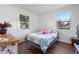 Cozy bedroom with lots of natural light, wood floors, and ample space for rest and relaxation at 8820 Poze Blvd, Thornton, CO 80229