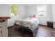 Bright bedroom with two windows, laminate flooring, and a comfortable queen-sized bed at 8820 Poze Blvd, Thornton, CO 80229