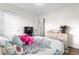 Bedroom with wood floors, neutral walls, and a comfortable bed with decorative pillows at 8820 Poze Blvd, Thornton, CO 80229