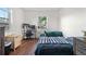 This cozy bedroom includes wood floors, a computer desk, and a window to create an ideal home office or study space at 8820 Poze Blvd, Thornton, CO 80229