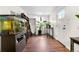 Bright entrance features wood floors, white walls, a large aquarium, house plants, and a front door with glass panels at 8820 Poze Blvd, Thornton, CO 80229