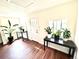Bright entryway with beautiful wood floors, light walls, and a white door with plants for decor at 8820 Poze Blvd, Thornton, CO 80229