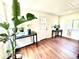 Bright entryway with beautiful wood floors, light walls, and a white door with plants for decor at 8820 Poze Blvd, Thornton, CO 80229