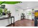 Bright entryway featuring pristine white walls, abundant natural light, and seamless wood flooring at 8820 Poze Blvd, Thornton, CO 80229